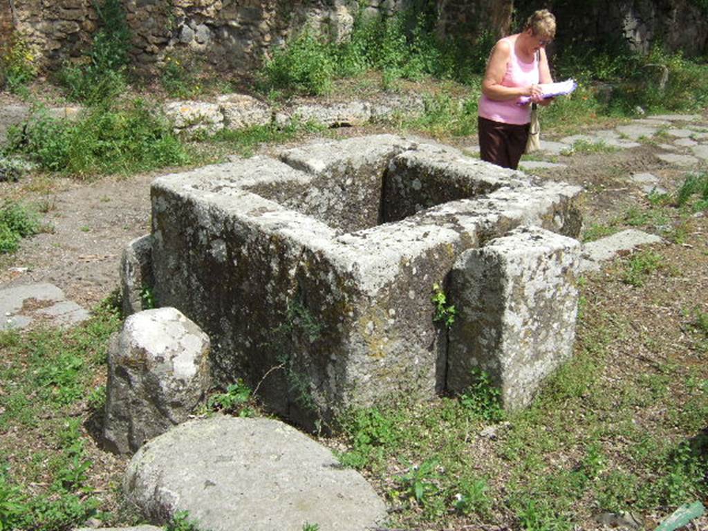 Via di Nola. May 2006. Looking north-east across street fountain on corner by III.11.f.
According to Eschebach, this fountain only had a basin and a fragment of the rear pilaster and no relief.
See Eschebach, H., 1983. Pompeii, Herculaneum, Stabiae; Bollettino dell�Associazione Internazionale Amici di Pompei 1, p. 12, Kat. Nr. 10. 
