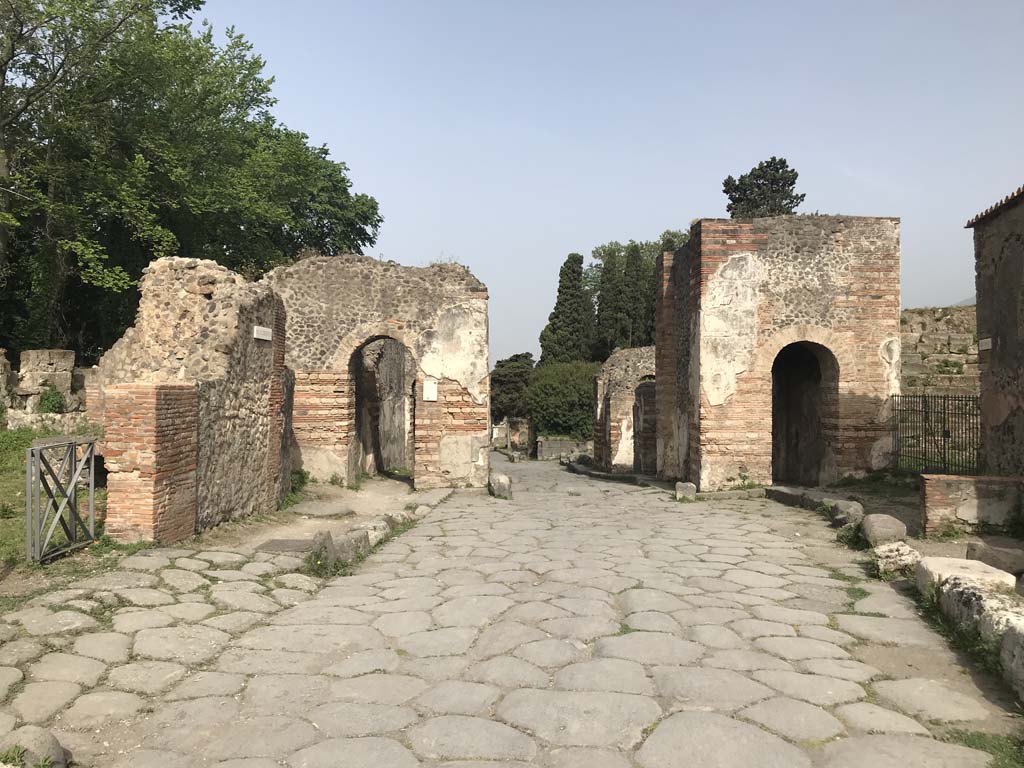 Porta Ercolano or Herculaneum Gate, Pompeii. April 2019. Looking north on Via Consolare. Photo courtesy of Rick Bauer.
According to Van der Graaff –
“The Porta Ercolano was the most monumental structure among the Pompeian gates (see Fig.3.9). 
The ruins exposed today represent its Flavian version, built as a monumental arch crowning the reconstruction effort following the earthquakes of the 60s CE (Note 72).
Its form is the result of the gate’s special status because of its position at the head of the Via Consolare, a busy regional road connecting Pompeii with Naples and, through the Via Domitiana, on to Rome (Note 73).”
See Van der Graaff, I. (2018). The Fortifications of Pompeii and Ancient Italy. Routledge, (p. 62 and Note 72 and 73).
And –
“The veru sarinu (salt gate), identified as the Porta Ercolano, received its name because it opened onto nearby salt (sarinu in Oscan – salienses in Latin) flats. (Note 132).”
See Van der Graaff, I. (2018). The Fortifications of Pompeii and Ancient Italy. Routledge, (p.106 and 107 and Note 132).

