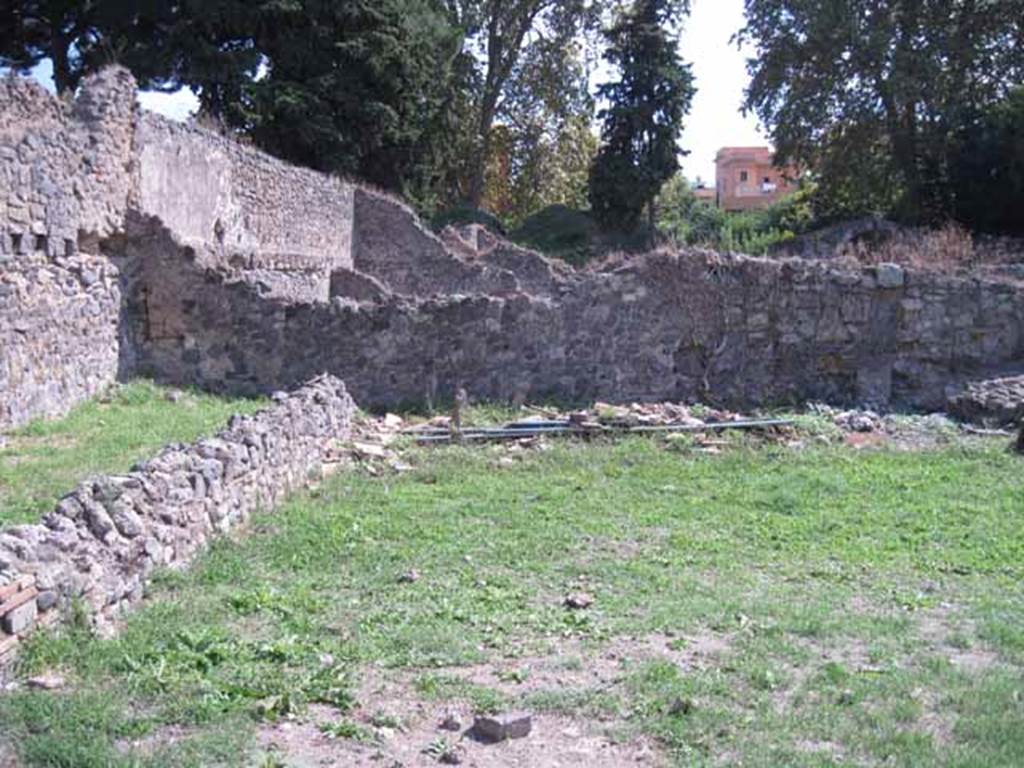 I.1.8 Pompeii. September 2010. Looking south across yard, behind the wall on the left would have been the stables area. Photo courtesy of Drew Baker.
