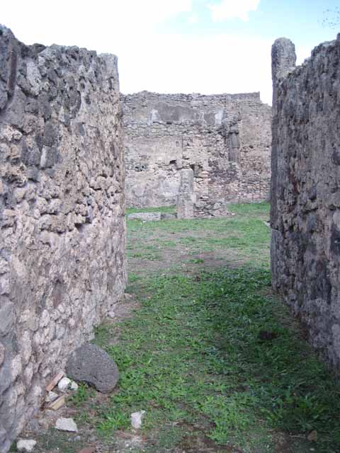 1.2.3 Pompeii. September 2010. Looking north towards remains of north wall (right or north-eastern corner of atrium). The north wall of house at I.2.6 is visible at the rear. Photo courtesy of Drew Baker.