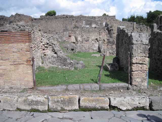 I.2.4 Pompeii. December 2006. Looking east across shop, towards the ruined wall separating it from the atrium of I.2.3.  
