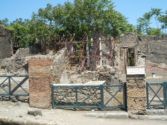 I.2.11 Pompeii. December 2007. Looking east across counter, north wall and towards small rear room.