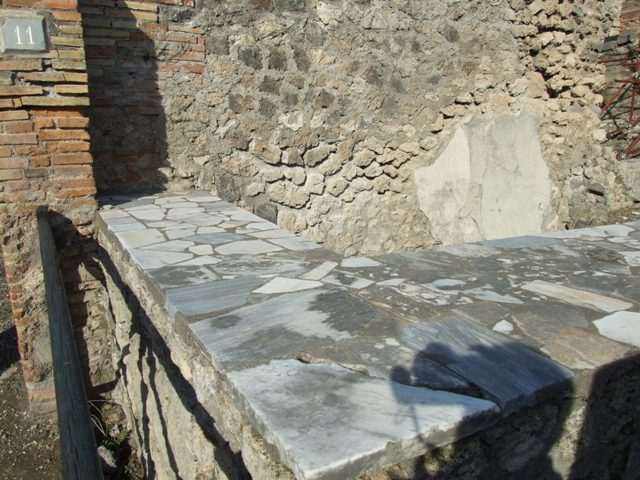I.2.11 Pompeii. September 2010. Looking south-west from behind counter towards Via Stabiana. Photo courtesy of Drew Baker.