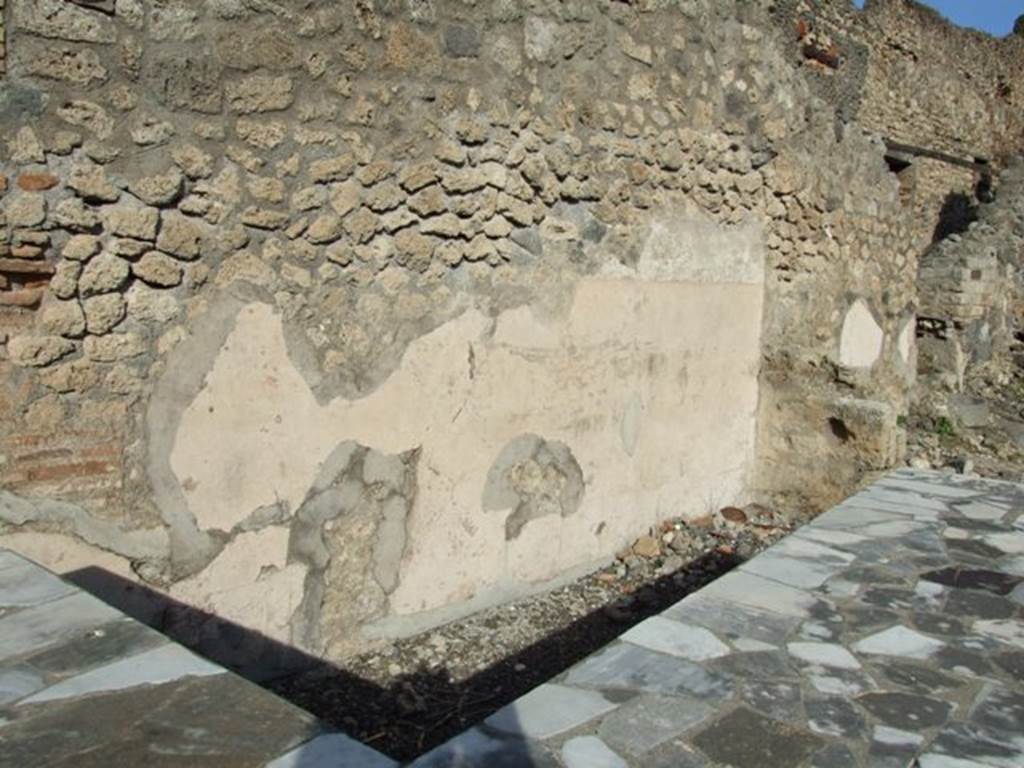 I.2.13 Pompeii. December 2007. North wall and area behind serving counter.  At the far end is the entrance to I.2.14 which was an independent staircase to a dwelling above I.2.13.

