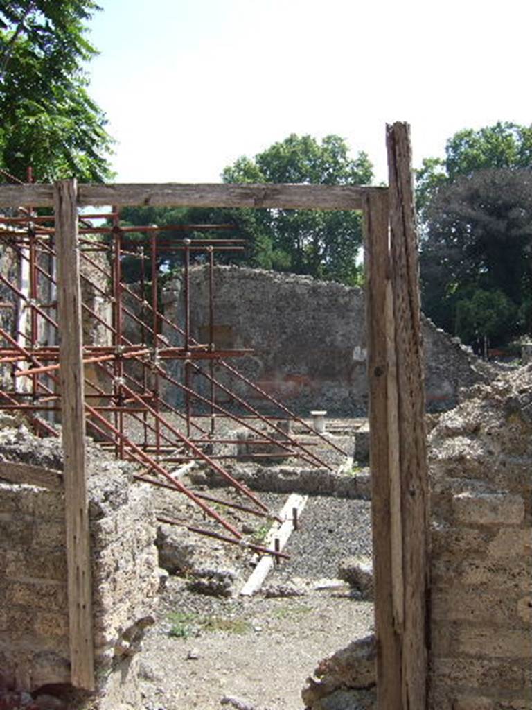 I.2.14 Pompeii. September 2005.  Entrance of independent staircase to dwelling above thermopolium at I.2.13.
Warscher described this, quoting Fiorelli, as I.2.14, gradinata indipendente, che menava a stanze sovrapposte alle botteghe 12 e 13.
See Warscher T., 1935. Codex Topographicus Pompeianus: Regio I.2. Rome: DAIR.
(translation: "I. 2.14, independent staircase, which led to the rooms above the shops 12 and 13.)
