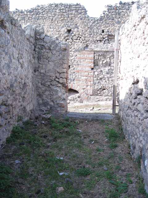 I.2.16 Pompeii. March 2009. Doorway to Room 2. Kitchen? with Well and Stairs to upper floor.