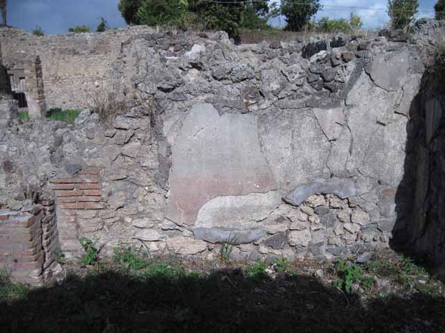 I.2.17 Pompeii. March 2009. Room 8, small garden at rear of tablinum.  
South wall and site of two raised pools, according to Mau. According to Fiorelli, the garden contained a basin or tub. See Pappalardo, U., 2001. La Descrizione di Pompei per Giuseppe Fiorelli (1875). Napoli: Massa Editore. (p. 36)
According to Jashemski, this very small garden (excavated in 1872) was entered from the tablinum. Much of the garden, according to Mau (she said) was occupied by two small adjacent raised pools. Attached to the west wall was a masonry pool, the other pool was to the south. There was a garden painting on the rear wall.
See Jashemski, W. F., 1993. The Gardens of Pompeii, Volume II: Appendices. New York: Caratzas. (p.23, & p.313, nos. 2 and 3)
She quoted the reference:  Mau. BdI (1874) pp.264-265.
