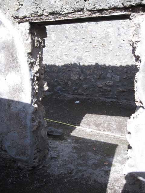 I.2.19 Pompeii. December 2006. Looking west from entrance towards doorways to two rear rooms on south side of bar.
