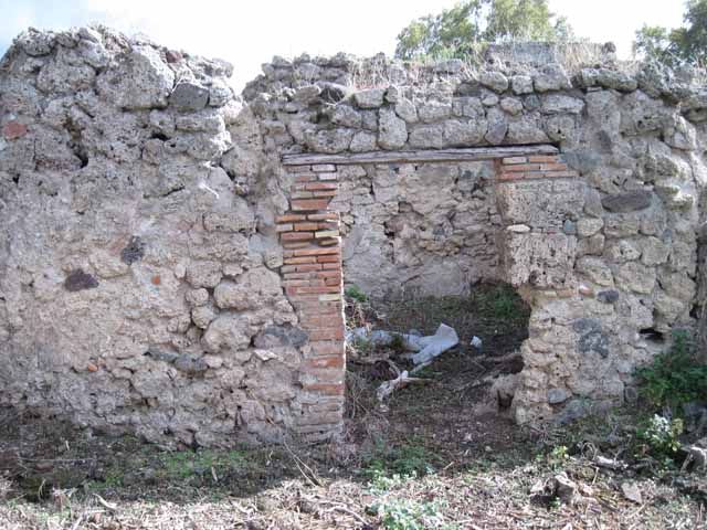 I.2.20 Pompeii. March 2009. West wall of kitchen area, with blocked archway to triclinium.