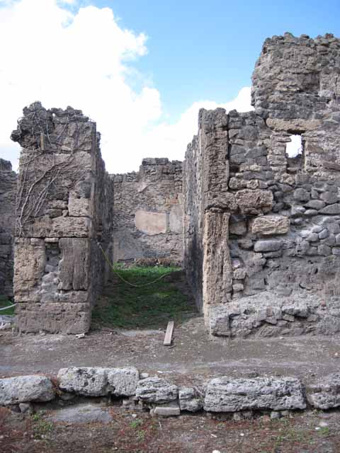 I.2.24 Pompeii. September 2010. South side of room, looking south through I.2.25 onto Vicolo del Conciapelle . Photo courtesy of Drew Baker.