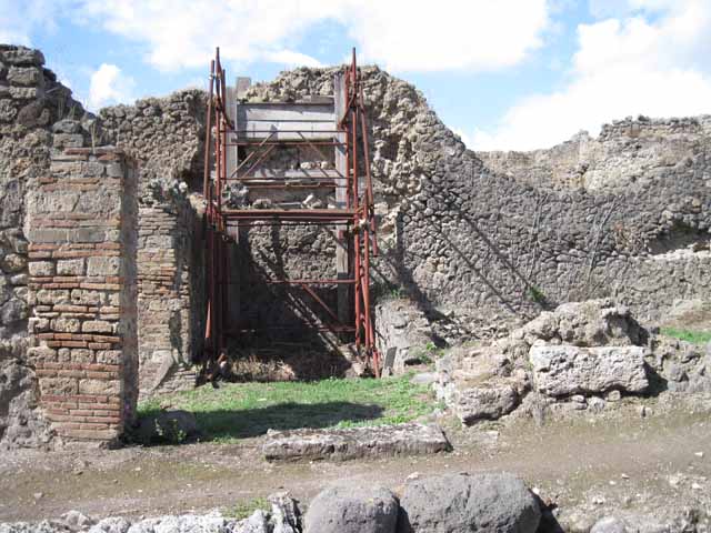 I.2.31 Pompeii. September 2010. West wall, with two doorways leading from two separate rear rooms into the main bar-room. Photo courtesy of Drew Baker.
