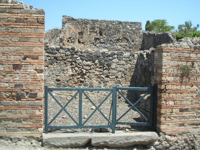 I.3.7 Pompeii. September 2010. South wall of shop, with brick podium in south-west corner. 
Photo courtesy of Drew Baker.

