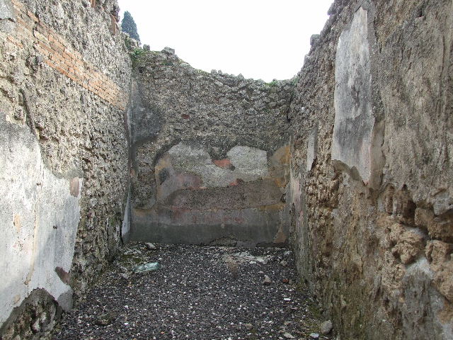 I.3.24 Pompeii. December 2006. Steps to upper floor, kitchen doorway and rear, south wall of house. According to Boyce, on this south wall of the peristyle was the Lararium painting. He described - The Genius, holding cornucopia against his left shoulder, poured a libation upon an altar from a patera held in his right.  Beside him stood a Camillus holding a shallow dish.  Opposite the Genius were the tibicen and the popa, the latter leading a pig to sacrifice. Only the Lar on the right remained.
In the lower zone, a single red and yellow serpent coiled towards an altar. Nothing now remains of this painting in situ.
See Boyce G. K., 1937. Corpus of the Lararia of Pompeii. Rome: MAAR 14. (p. 24) 
