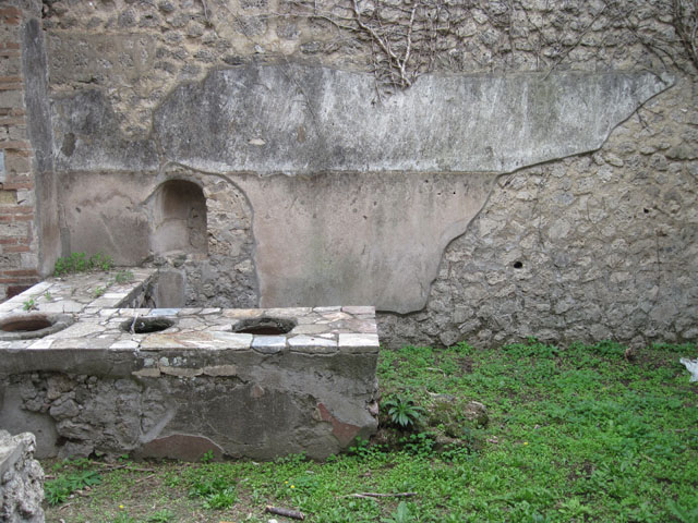 I.3.28 Pompeii.  March 2009. Remains of painted plaster on interior north side of counter.