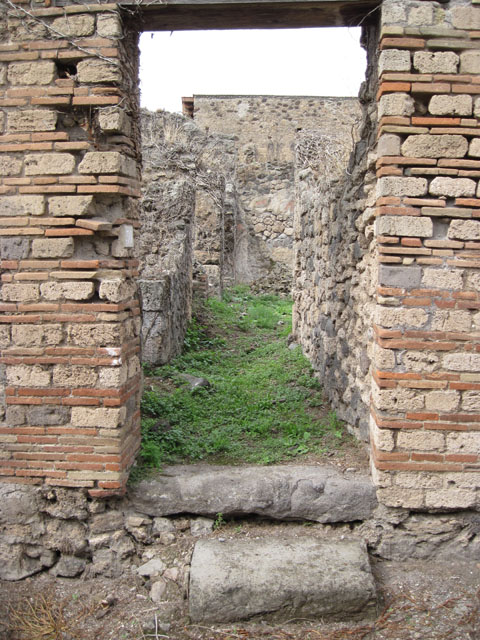I.3.30 Pompeii. September 2010. ID number plate on west side of entrance doorway.
Photo courtesy of Drew Baker. Looking west along unnamed vicolo towards Via Stabiana. Fiorelli called this vicolo “via secunda”. See Pappalardo, U., 2001. La Descrizione di Pompei per Giuseppe Fiorelli (1875). Napoli: Massa Editore. (p.41)