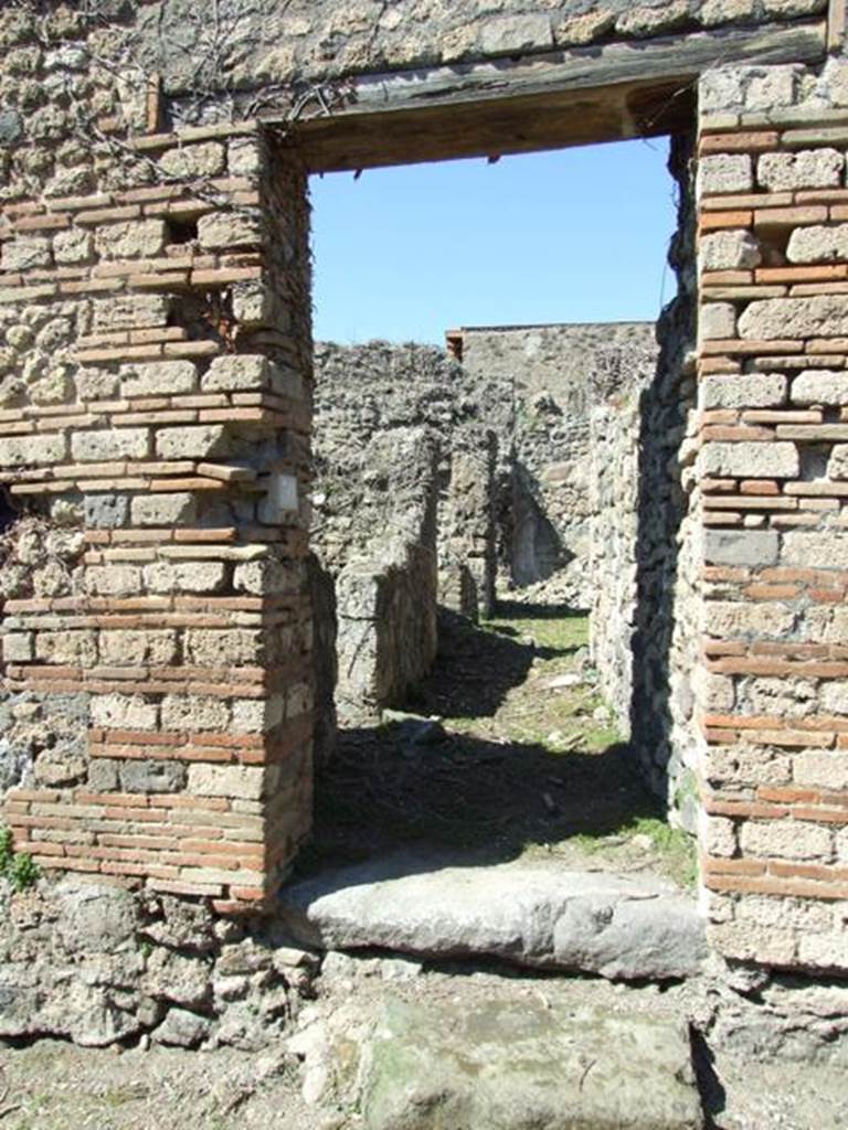 I.3.30 Pompeii. March 2009. Entrance doorway, looking north along entrance corridor.
According to Warscher, quoting Fiorelli, this was a house in the southern roadway known as Via Secunda. The entrance corridor was bordered by the kitchen, which was near a staircase, after which was the lararium painted with the Lares with rhyton and situla, now completely faded. In the storeroom a painted graffito was found 
XV K AVGVSTAS
PARTISCA ESERNIE
FVIT            (CIL IV 3388)
See Warscher, T, 1935: Codex Topographicus Pompejanus, Regio I, 3: DAI,  Rome.  
