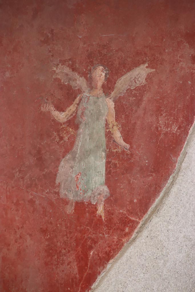 I.6.4 Pompeii. October 2022.
Room 5, detail of flying figure from north end of east wall. Photo courtesy of Klaus Heese. 
