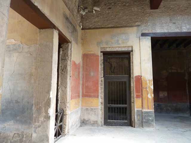 I.10.4 Pompeii. May 2010. Atrium, north wall on the west side. Painted panel with architectural scene on upper north wall.