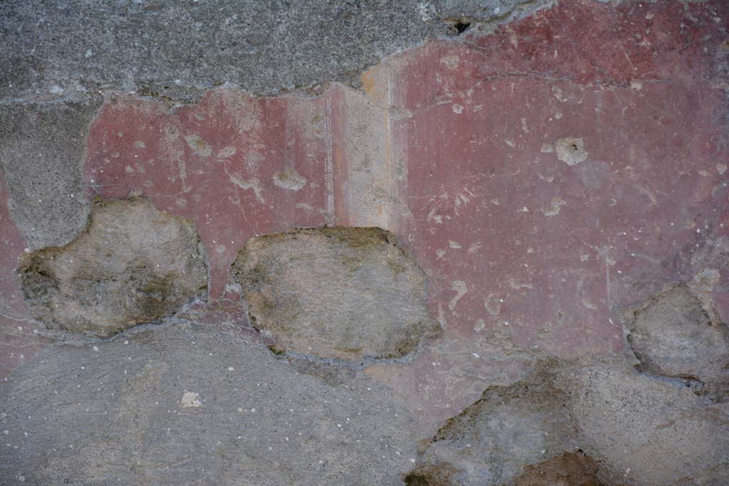 I.10.5 Pompeii. April 2017. Detail of painted plaster on exterior front faade on east side of entrance doorway. 
Photo courtesy Adrian Hielscher.
