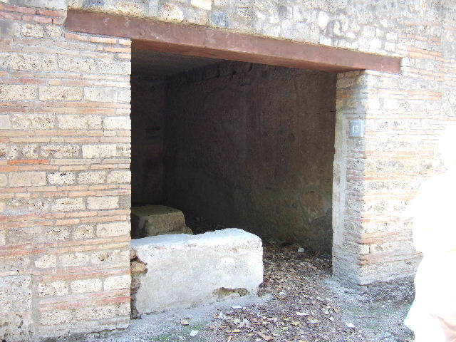 I.10.13 Pompeii. September 2005. Remains of two-sided stuccoed masonry podium.