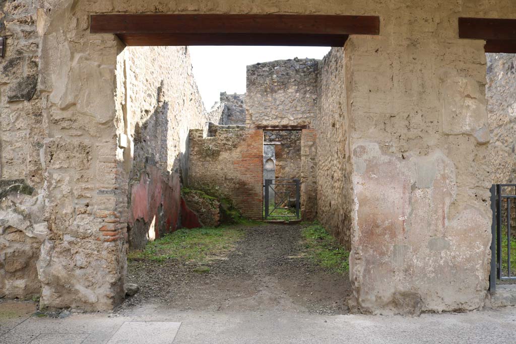 I.11.3 Pompeii. December 2018. 
Looking towards entrance doorway on south side of Via dellAbbondanza. Photo courtesy of Aude Durand.

