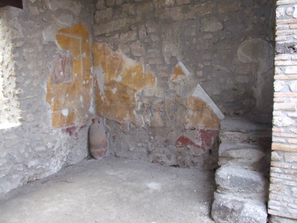 I.11.6 Pompeii. March 2009. Room 5. Tablinum. West wall with stairs to upper floor, and amphora in south west corner.