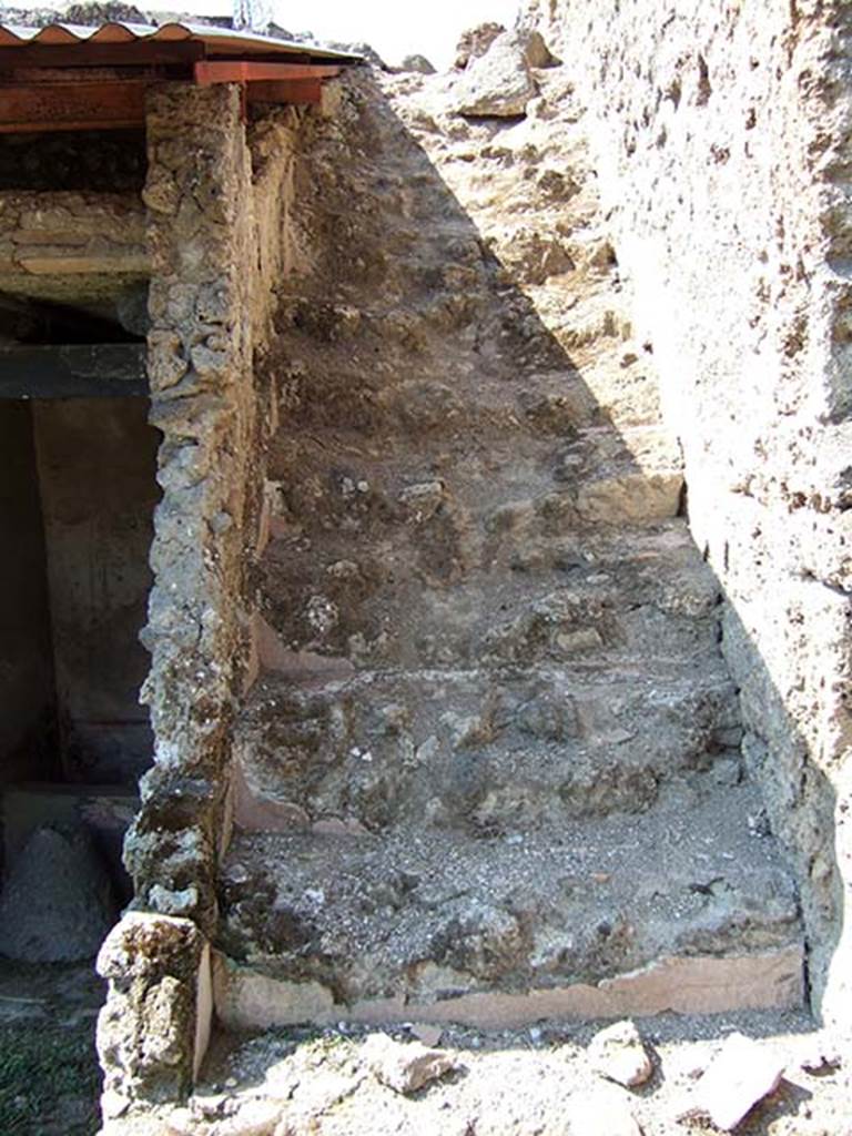 I.11.10 Pompeii. September 2005. 
Stairs to upper floor, with latrine at the rear on the left.
