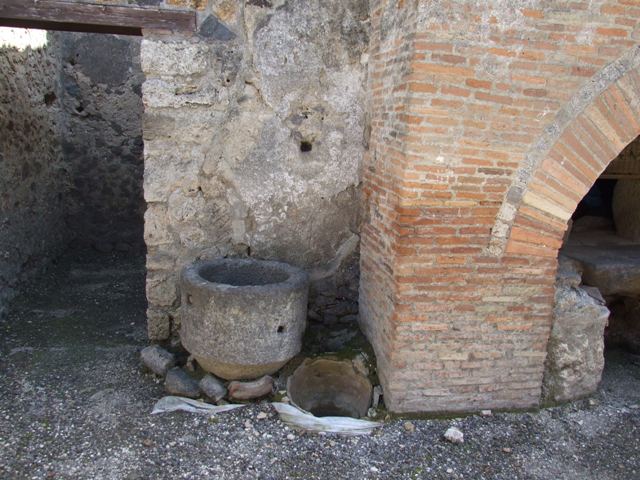 I.12.2 and I.12.1 Pompeii.  March 2009  Room 13. East wall, with remains of holes for shelving supports.