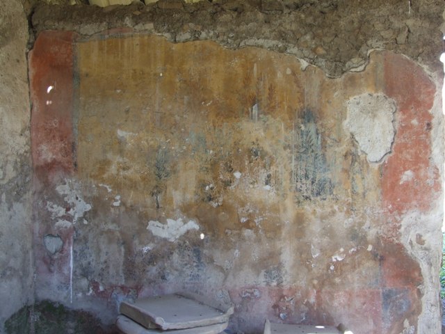 I.12.8 Pompeii. March 2009. Room 9, west side of north wall with remains of garden painting.  According to Curtis, the major panels of the painting depicted a garden scene with thick foliage. The left panel was much deteriorated, but both panels contained paintings of life-like birds standing on branches of green trees and shrubbery. According to Jashemski, she could see four song-birds in a thicket of ivy, flowering oleanders and myrtles.
The bottom part of the painting was destroyed. See Jashemski, W. F., 1993. The Gardens of Pompeii, Volume II: Appendices. New York: Caratzas, (p.326 and fig.378)

