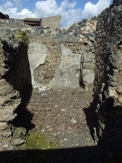 I.12.15 Pompeii. March 2009. Square masonry base in south east corner outside room 6.