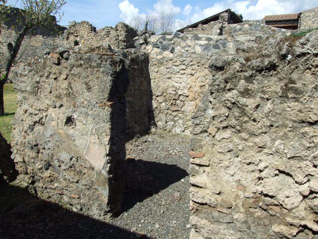 I.12.15 Pompeii. March 2009. Room 7. Remains of painted plaster in north east corner