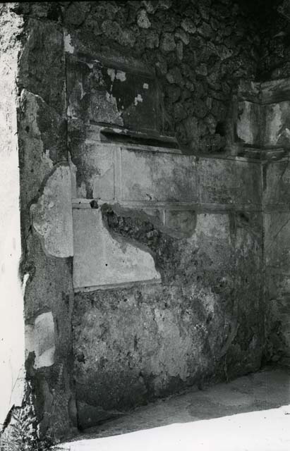I.13.2 Pompeii. May 2010.  Remains of painted wall plaster above doorway on east side of atrium.