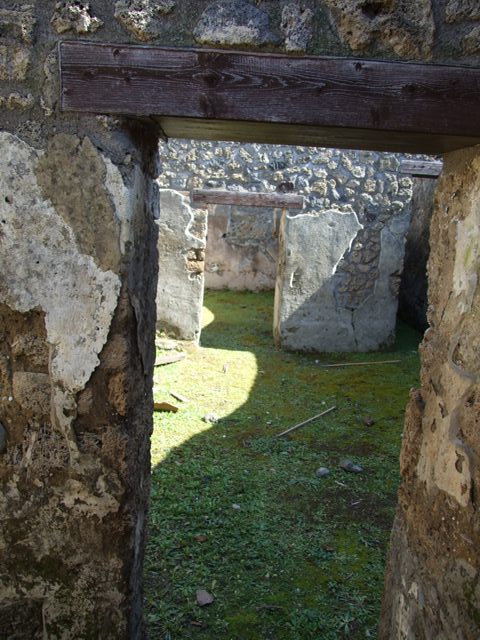 I.13.15 Pompeii. March 2009. Room on north-east side of central courtyard, looking at north-east corner and north wall.