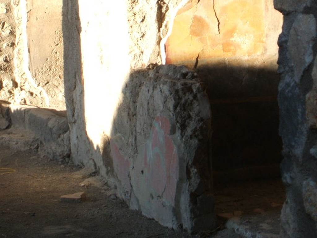I.14.13 Pompeii. December 2004. Remains of painted wall plaster in room on east side of portico room 32, of 1.14.12.