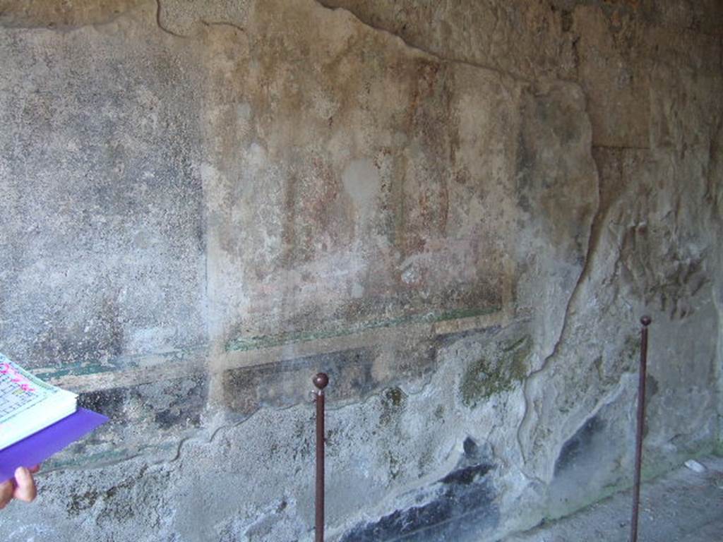 I.16.5 Pompeii. September 2005. Remains of central painting on painted wall in room on east side of peristyle.