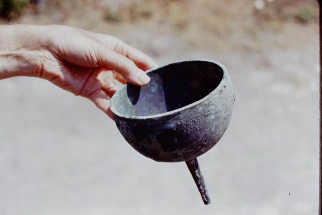 I.20.5 Pompeii. 1973. Bronze funnel found by the original excavators. Photo by Stanley A. Jashemski. 
Source: The Wilhelmina and Stanley A. Jashemski archive in the University of Maryland Library, Special Collections (See collection page) and made available under the Creative Commons Attribution-Non Commercial License v.4. See Licence and use details. J73f0578
See Cronache Pompeiane 1, 1975: Jashemski, W. The gardens of Pompeii, (p.69-71).
