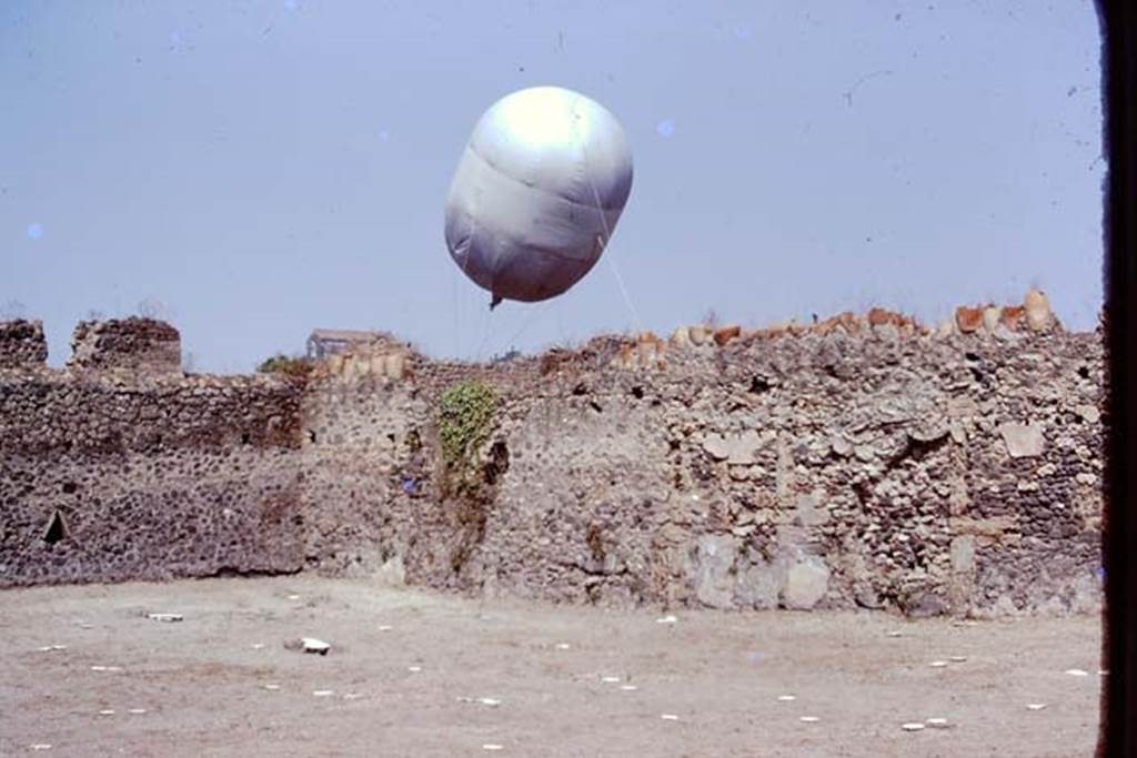 I.20.5 Pompeii. 1974. Looking towards north-west corner, and the “balloon” in Via della Palestra.  Photo by Stanley A. Jashemski.   
Source: The Wilhelmina and Stanley A. Jashemski archive in the University of Maryland Library, Special Collections (See collection page) and made available under the Creative Commons Attribution-Non Commercial License v.4. See Licence and use details. J74f0442

