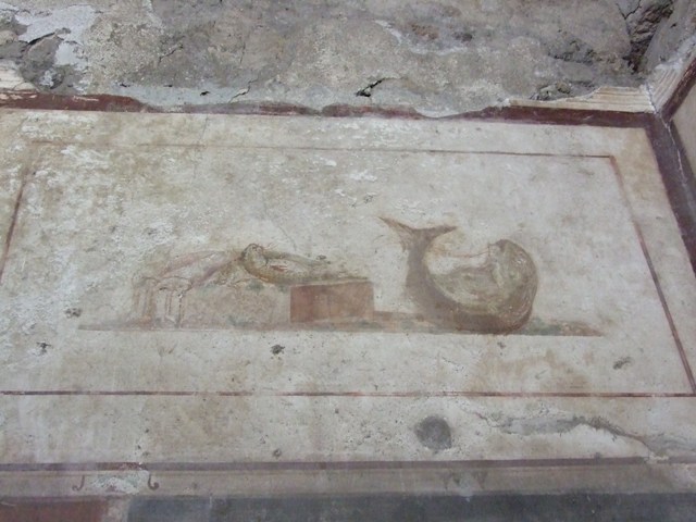 II.1.12 Pompeii. March 2009. Remains of wall painting on south wall of triclinium.