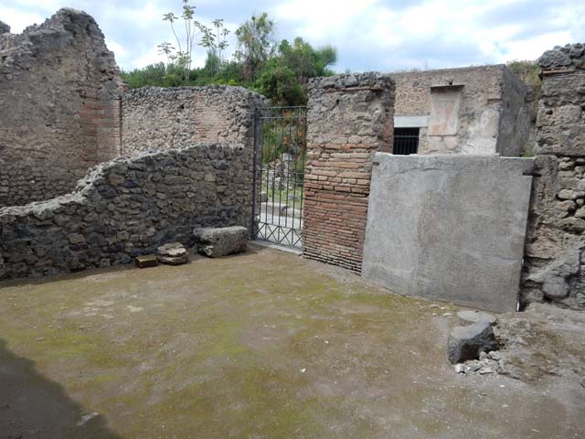 II.3.2 Pompeii. December 2007. Remains of painted plaster on east wall of workshop.