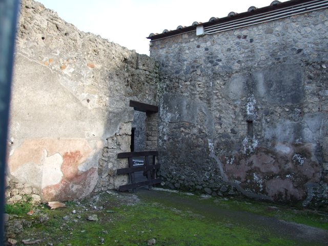 II.3.2 Pompeii. March 2009. South wall of Yard on west of workshop, with doorways to two rooms.