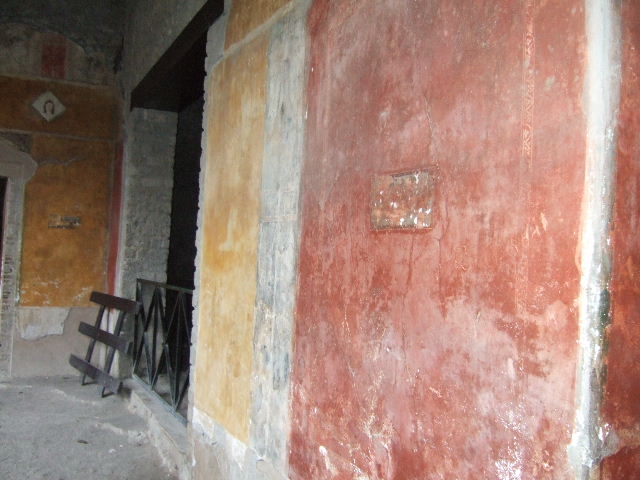 II.3.3 Pompeii.  March 2009.  Room 11, North Portico. Wall between doorways to Room 5 and Room 12.