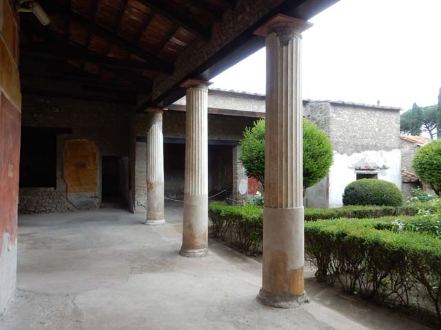 II.3.3 Pompeii. March 2009. Doorway to room 12, painted candelabrum on north side.