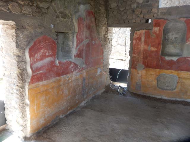 II.4.6 Pompeii. 1807. Engraving of the sacrarium. According to Boyce, on three walls of a small sacellum-like room with vaulted ceiling, were sacred paintings. These were done on a white background above a dado filled with plants. In the centre, was Isis seated upon a throne. On her left stood Anubis, wearing a dark garment and sandals, his head turned towards Isis. On the left side wall were poorly preserved figures, a woman who seemed to be rolling a globe on the floor, and a male figure holding a cornucopia. On the right of Isis in the centre, stood a poorly preserved figure holding a staff in right, and a cornucopia in the left hand. On the right side wall stood a female figure, holding in her right hand, a shallow dish with eggs and fruit, which she is offering to a serpent. See Boyce G. K., 1937. Corpus of the Lararia of Pompeii. Rome: MAAR 14. (p.95, no.471)
According to Boyce’s description, this print is inaccurate in several points. Isis should be seated upon a throne, but is standing in the centre. On her left, Anubis should be wearing sandals. On his left, the female figure has no cornucopia.
Piranesi described it as “Niche dans le temple d’Isis a Pompeia”. Fröhlich attributed it to this house and comments that Piranesi and Helbig contradict each other on some points.
This sacrarium was taken to the Museum at Portici and reconstructed there, and then transferred to the National Museum. By around 1885, it had faded and perished apart from the lower portion showing the serpents. In Naples Archaeological Museum it was inventory number 9693. See Pagano, M. and Prisciandaro, R., 2006. Studio sulle provenienze degli oggetti rinvenuti negli scavi borbonici del regno di Napoli. Naples: Nicola Longobardi. (p.17 and note 47).
See Piranesi F., 1807. Antiquités de la Grande Grèce, aujourd'hui royaume de Naples. Paris: Etablissement des Beaux-Arts. (Plate 1).
See Fröhlich, T., 1991. Lararien und Fassadenbilder in den Vesuvstädten. Mainz: von Zabern. (L40, p. 265, Taf 30,1).
See Helbig, W., 1868. Wandgemälde der vom Vesuv verschütteten Städte Campaniens. Leipzig: Breitkopf und Härtel. (No 79).
See Parslow, C.C. (1998). Rediscovering Antiquity: Karl Weber and the Excavation of Herculaneum, Pompeii and Stabiae. UK,Cambridge UP (p.110, & p.345, notes 8 & 9)
