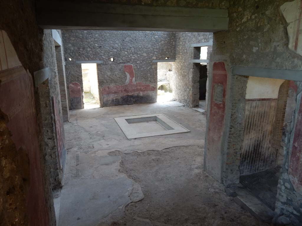 II.4.10 Pompeii. June 2019. Looking south across atrium towards doorways on south side.
Photo courtesy of Buzz Ferebee. 
