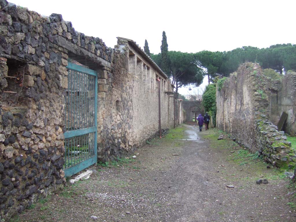 II.4.12 Pompeii, on left. December 2006.                    Roadway looking south.                           II.3, on right.