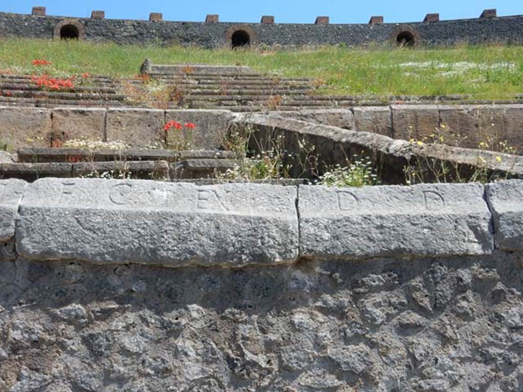 II.6 Pompeii. May 2016. Inscription carved on rim of inner wall of the arena of the Amphitheatre.
Inscription D CVN, part of CIL X 855. Photo courtesy of Buzz Ferebee.
