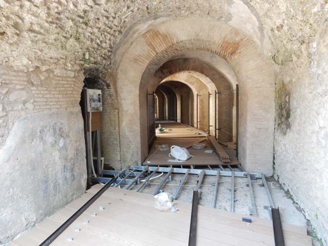 II.6 Pompeii. March 2009. Looking north-west from upper level of the Amphitheatre. In the night raid of 20th September 1943, one bomb fell onto the arena, and another towards the north side. This caused the demolition of part of the enclosing wall of the arena, and a section of seats of the ima cavea on the north-west side. See Garcia y Garcia, L., 2006. Danni di guerra a Pompei. Rome: L’Erma di Bretschneider. (p.46)