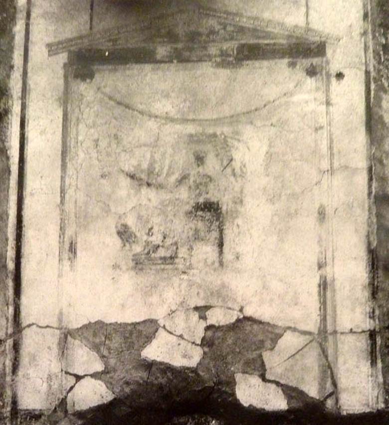 V.2 Pompeii. Casa di Orione. Old undated photograph. 
North wall of peristyle garden 11c (A19). Remains of central painting in lararium.
Giove (Jupiter) sits on a throne, his lower body covered with a green robe. 
The sceptre is in the left hand, leaning on the arm of the throne. 
The lightning bolt is in his outstretched right hand and the eagle at his feet. 
See Notizie degli Scavi di Antichità, 1894, p. 439.

