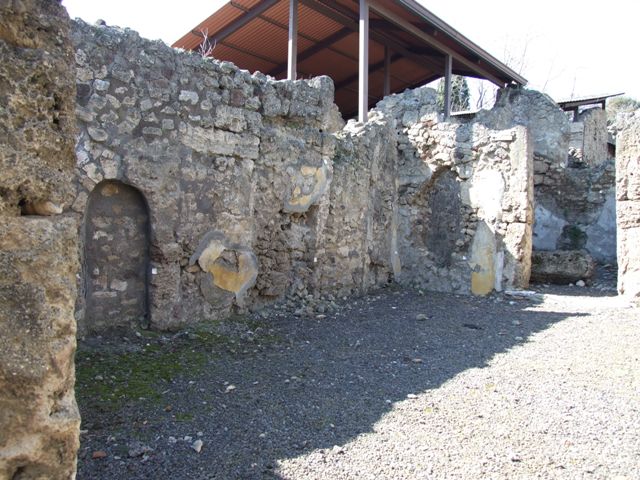 V.3.7 Pompeii.  March 2009. Triclinium.  East wall with door to passageway.