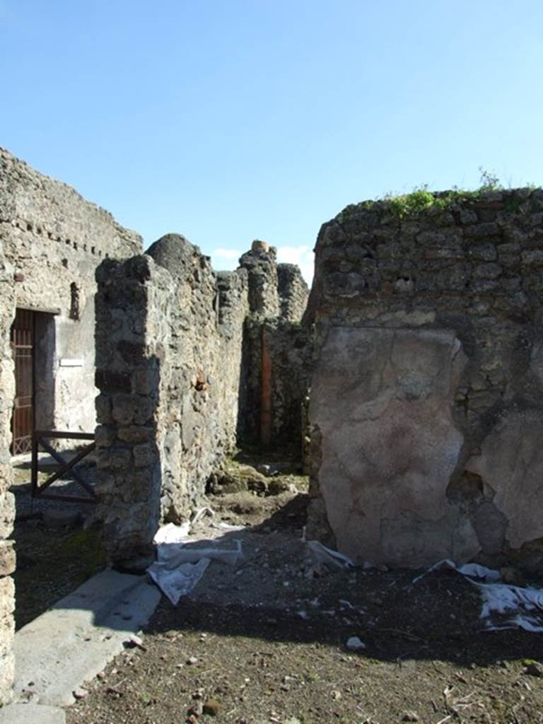 V.3.10 Pompeii.  March 2009.  Doorway to Kitchen and Latrine, on south side of atrium.